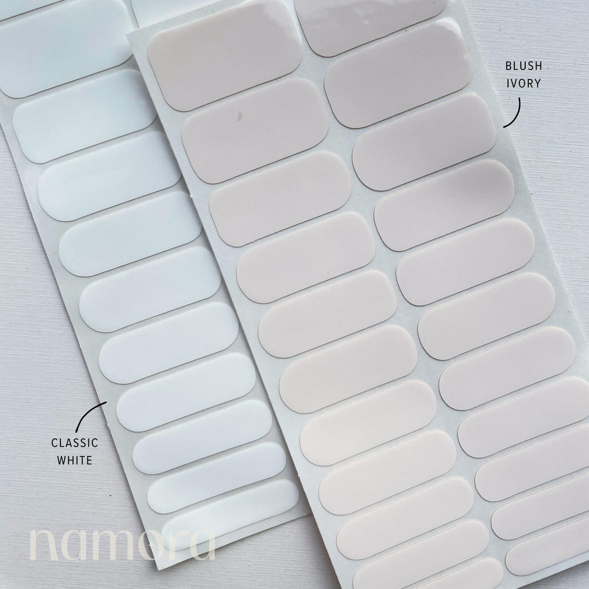Strips of blush ivory and classic white nail wraps by namora