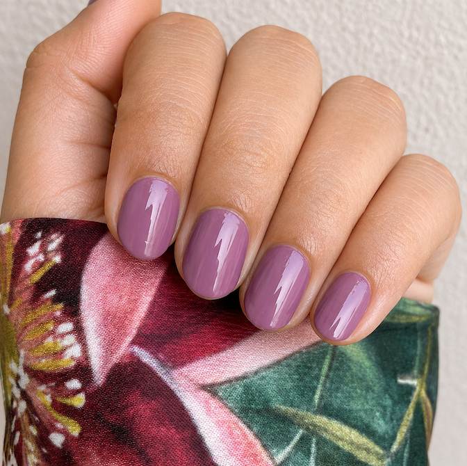 Hand wearing deep Plum nail Wraps by Namora