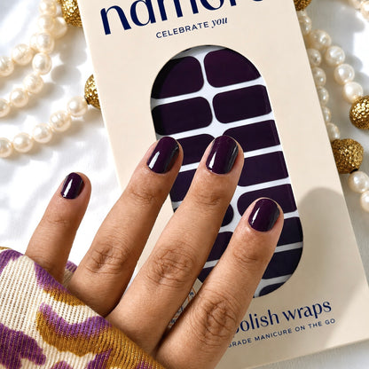 Nail polish wraps packaging with a hand displaying aubergine nails.