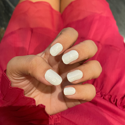 Hand wearing blush ivory nail wraps by namora
