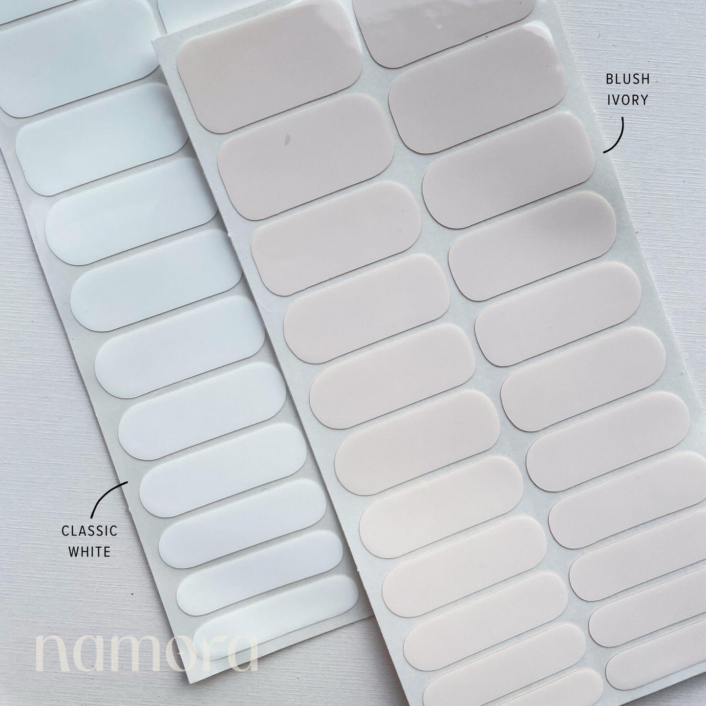 Strips of blush ivory and classic white nail wraps by namora
