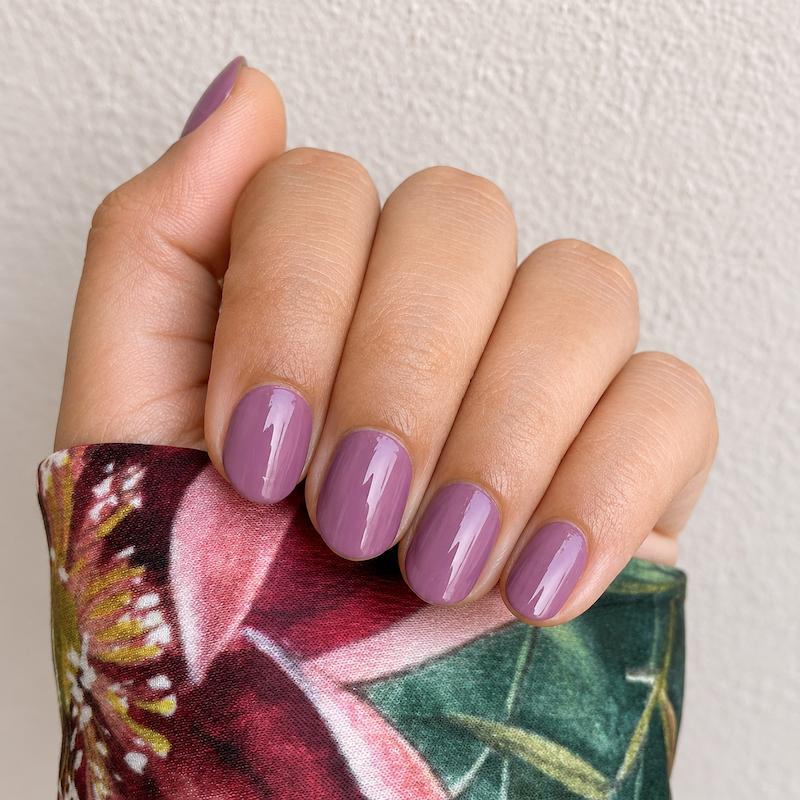 Hand wearing deep Plum nail Wraps by Namora
