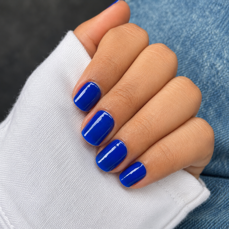 Hand wearing Electric Blue  nail wraps by namora