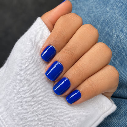 Hand wearing Electric Blue  nail wraps by namora
