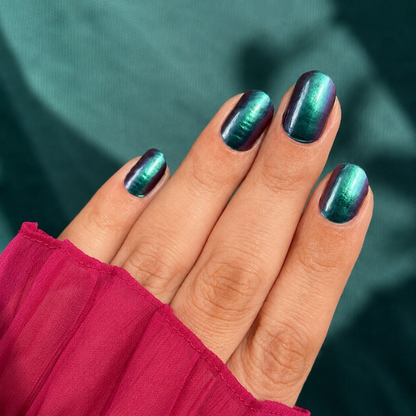 Hands wearing green chrome Nail Wraps by Namora 