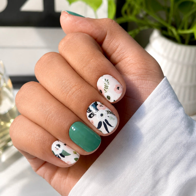 Hand wearing Moon Garden nail wraps by Namora