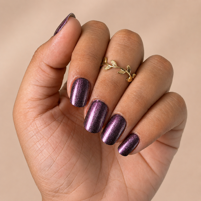 Hand wearing Mulberry Chrome nail wraps by Namora