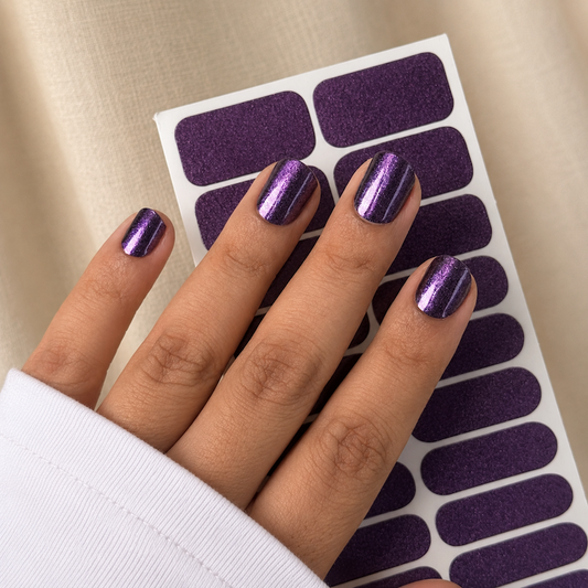 Hand wearing Mulberry Chrome Nail Wraps by Namora
