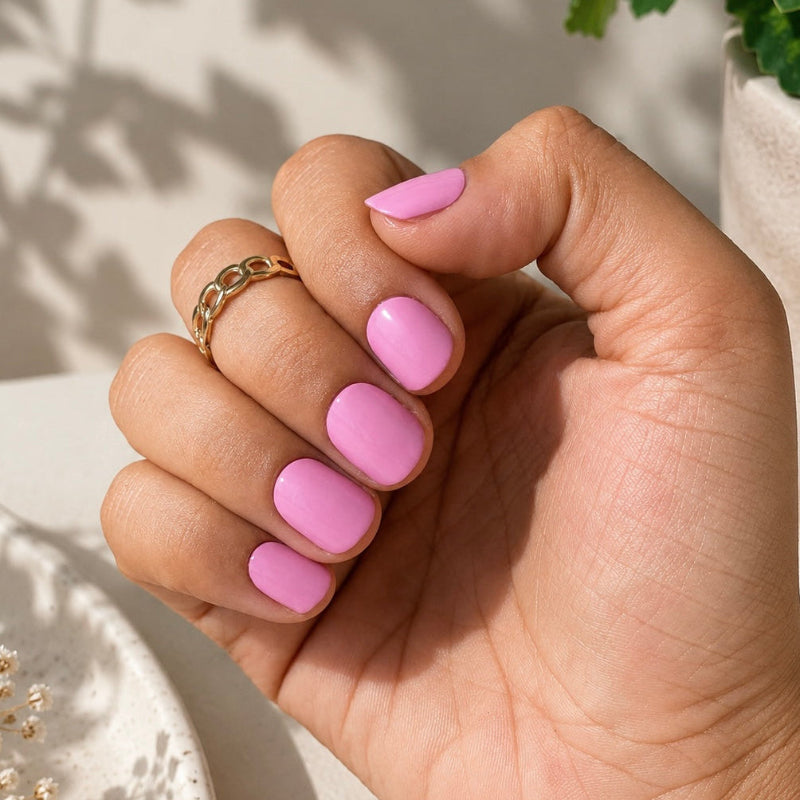 Hand wearing Pink Perfect Nail Wraps by Namora