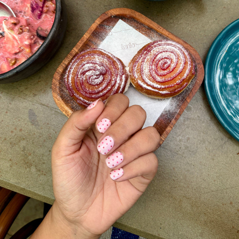 Hand wearing pinkn and polka nail wraps by namora