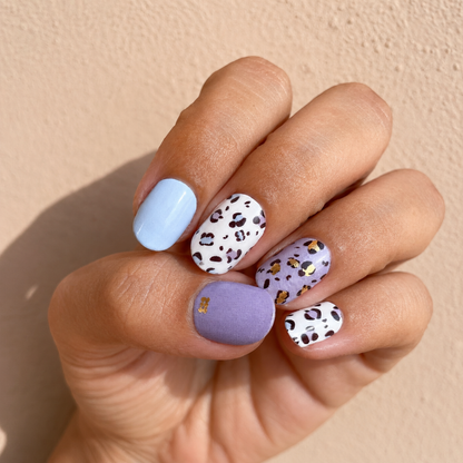 Hand wearing Purple Panther nail wraps by namora