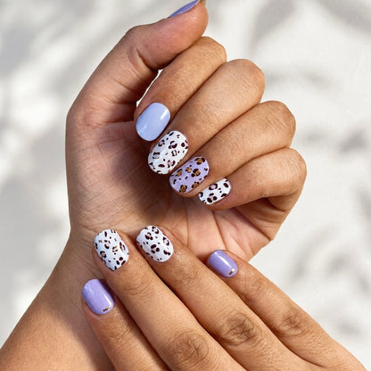 Hand wearing Purple Panther nail wraps by Namora