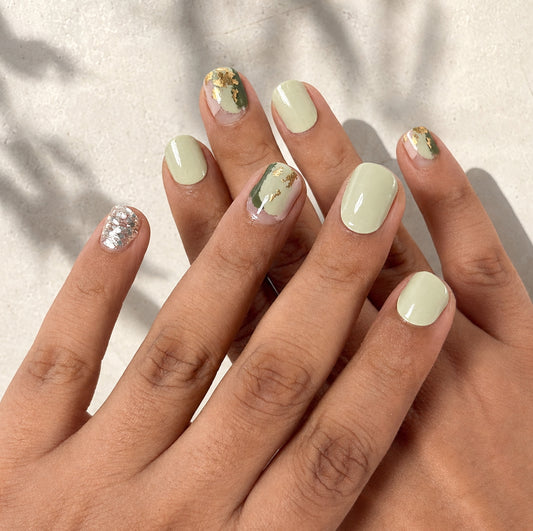 Hands wearing Sage Martini Nail Wraps by Namora 